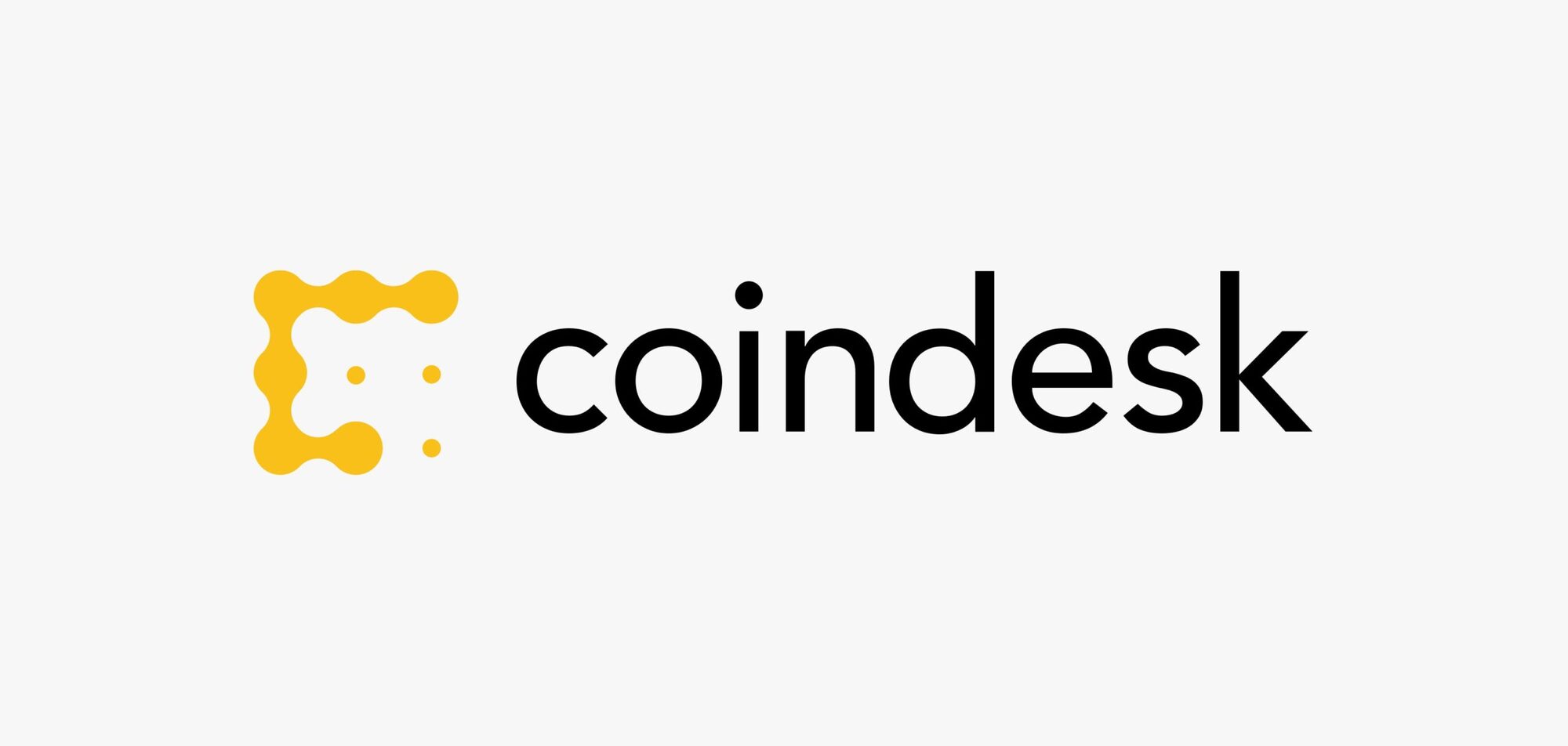 The CoinDesk logo: a yellow letterform built from fused circles beside the lowercase wordmark coindesk in near-black.
